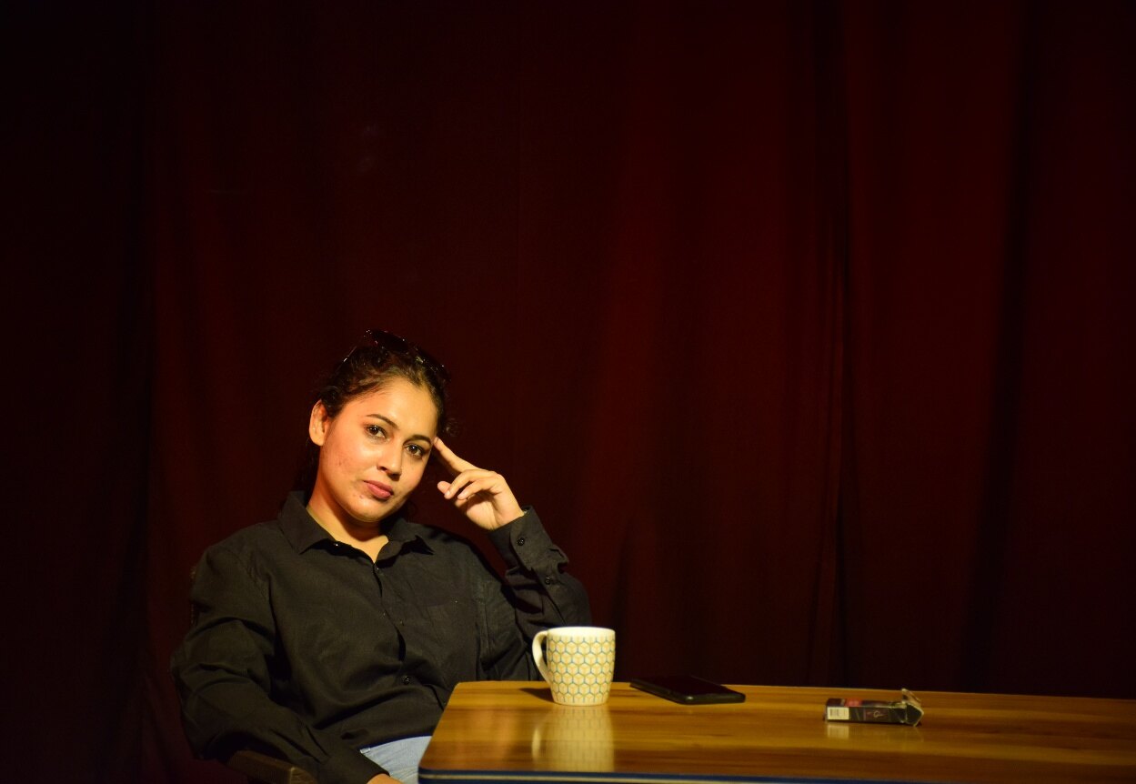 Cinematic seated portrait on stage