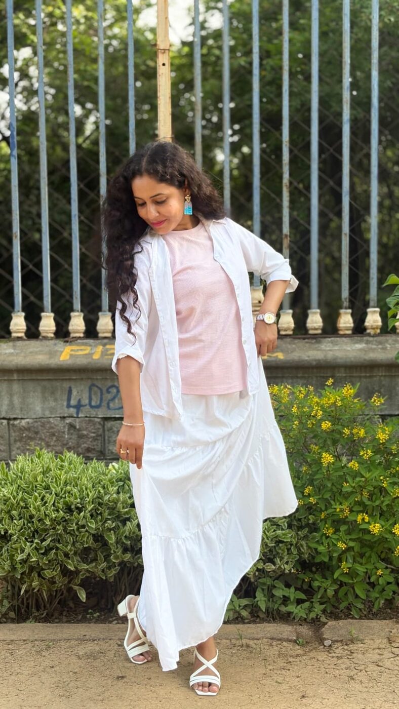Gayatri Rampelli in an ivory shirt-dress, outdoor portrait